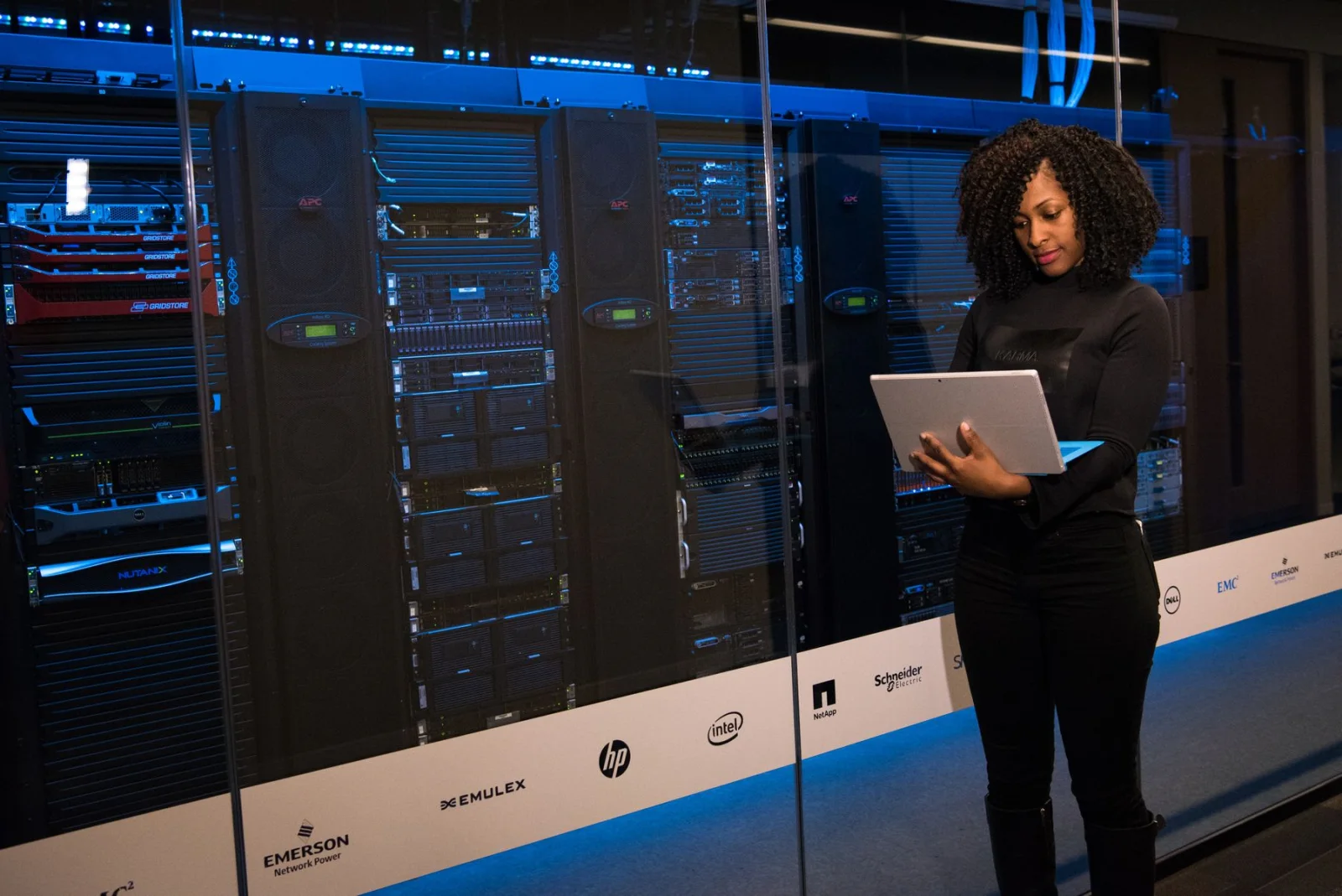 IT engineer working beside enterprise server and network infrastructure during technical delivery.