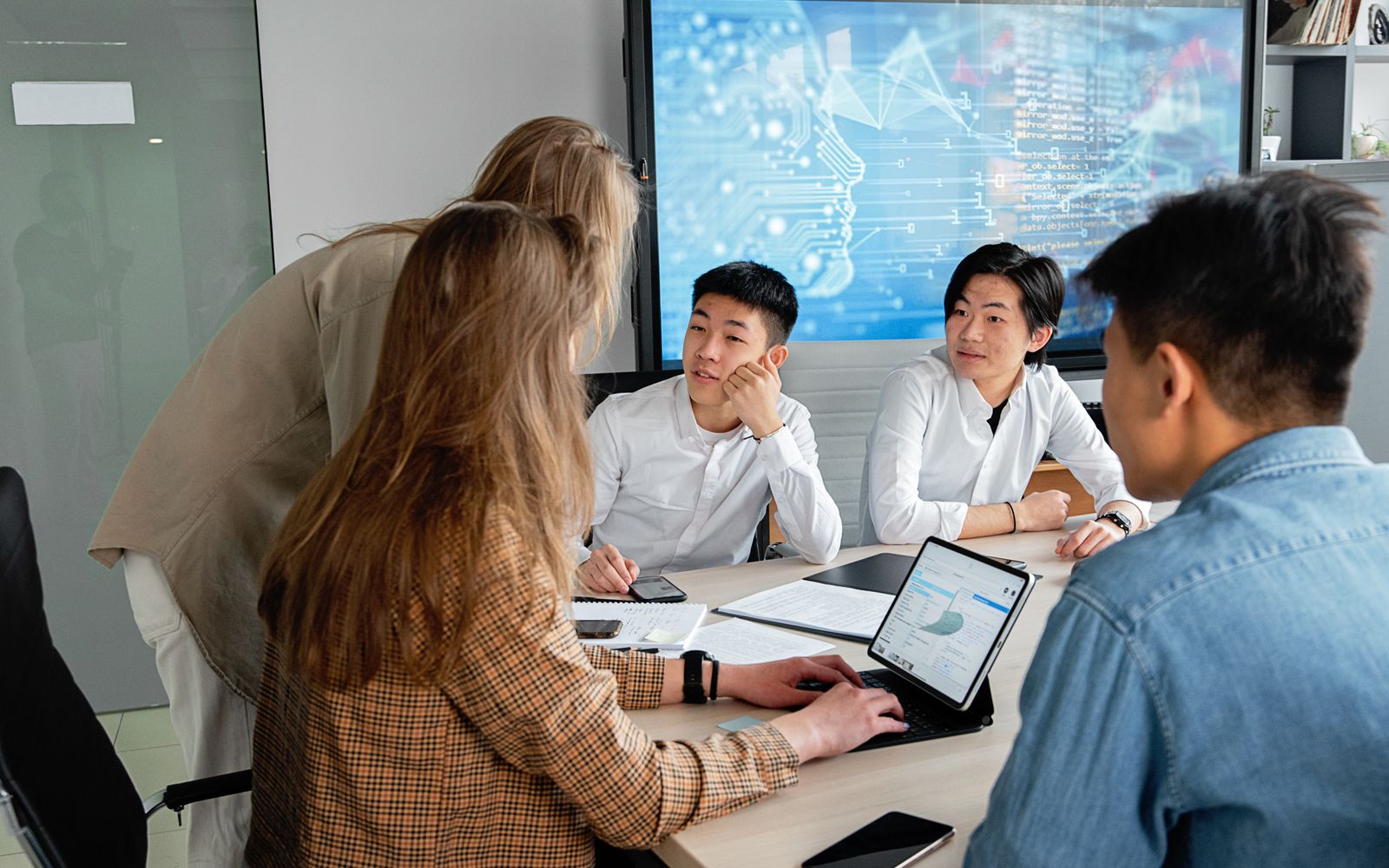 Technology professionals collaborating during a planning meeting in a modern office.