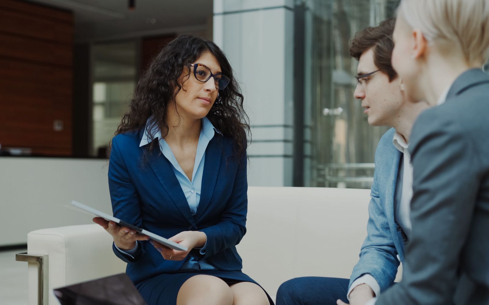 Professional team discussing requirements during a client consultation in a modern office.