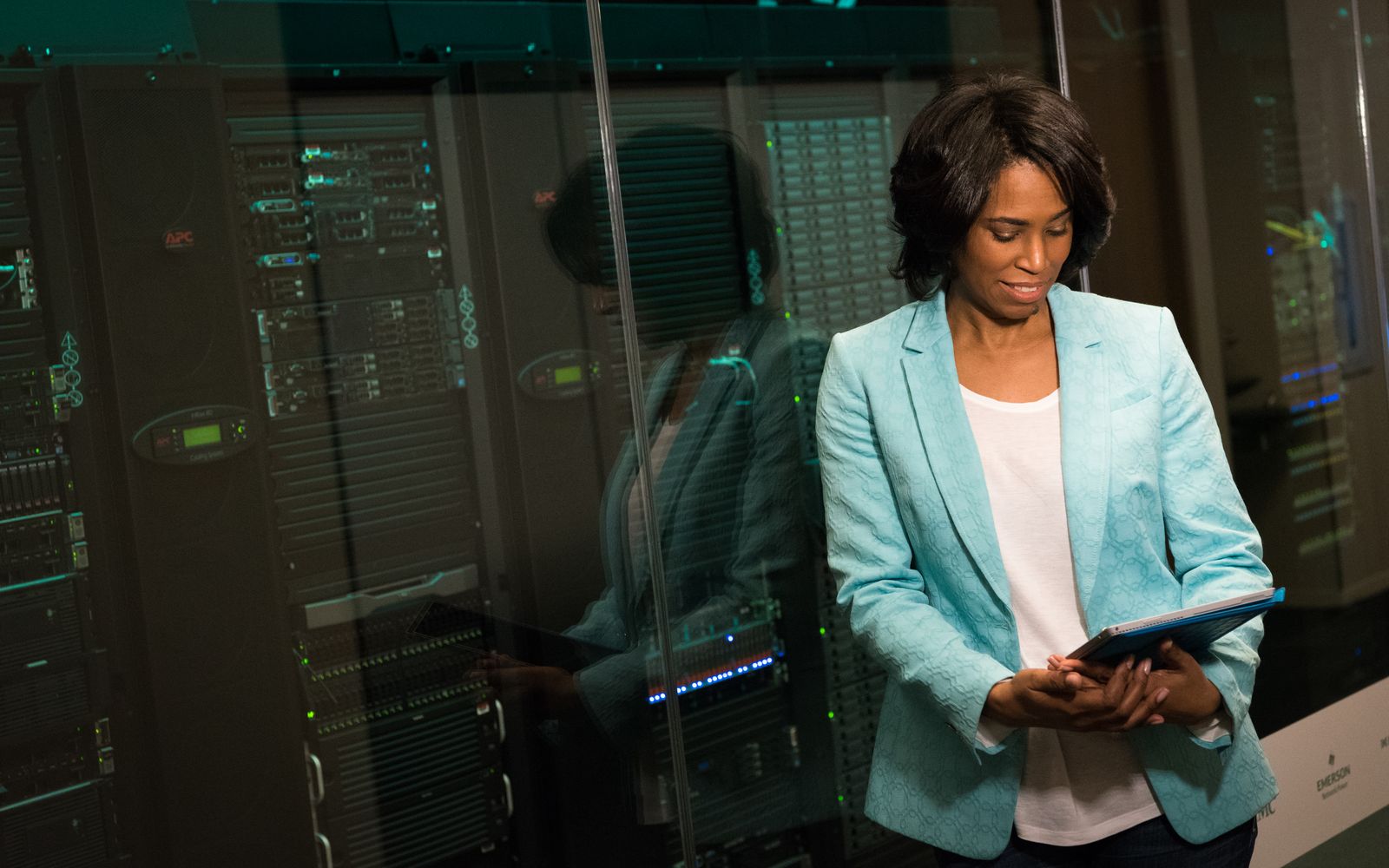 IT professional reviewing enterprise server and network infrastructure in a modern data-center environment.