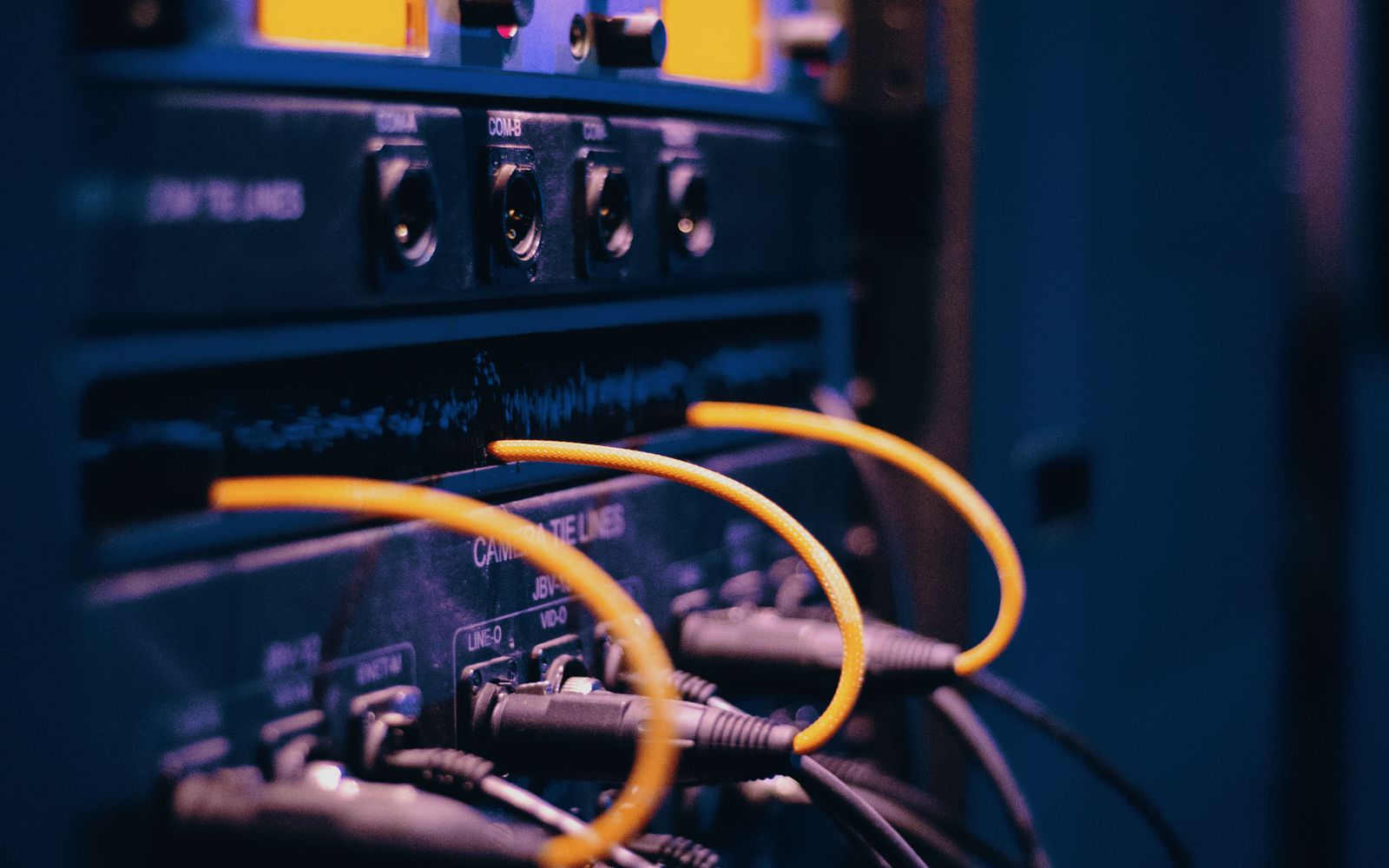 Close-up of enterprise network cables and ports in a server rack representing solution architecture and connectivity.