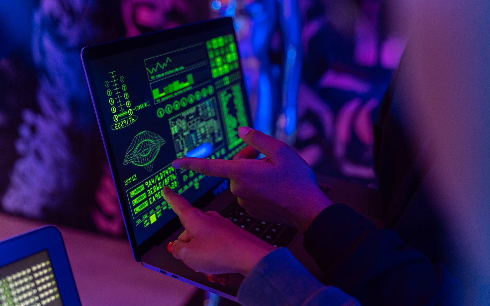 Cybersecurity professional reviewing technical findings and exposure data on a workstation.